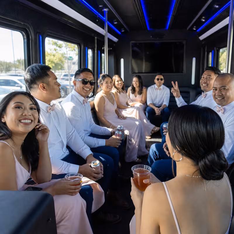 Wedding guests seated inside a San Bernadino party bus
