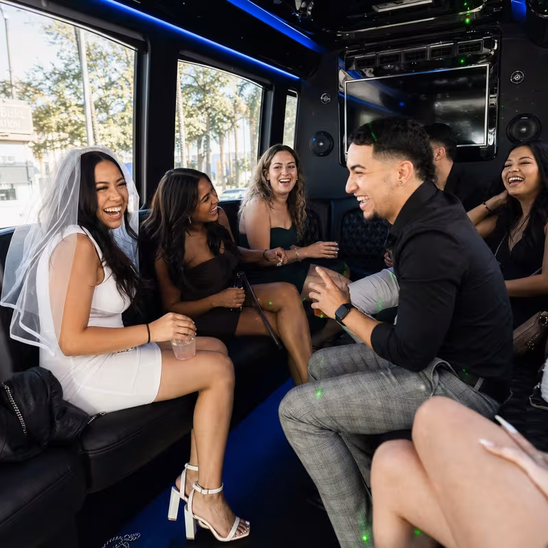 Party bus interior with wraparound leather seating and LED lighting in San Bernadino