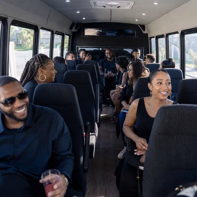 Group boarding a white charter bus for Private Event Transportation transportation in San Bernadino