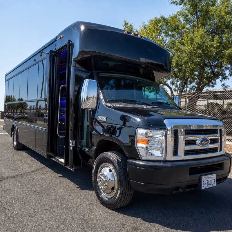 Party bus interior with wraparound leather seating and LED lighting in San Bernadino