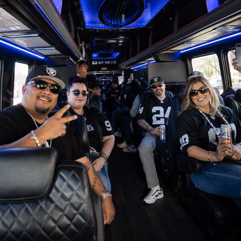 Group boarding a white charter bus for Sporting Event Transportation transportation in San Bernadino