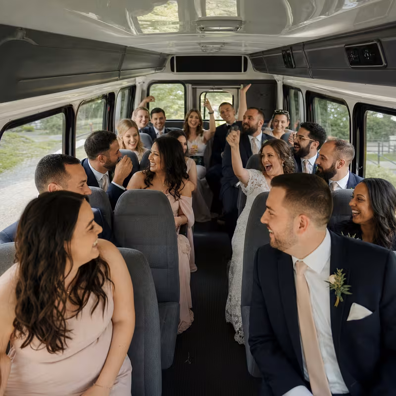 Group boarding a white charter bus for Wedding Transportation transportation in San Bernadino