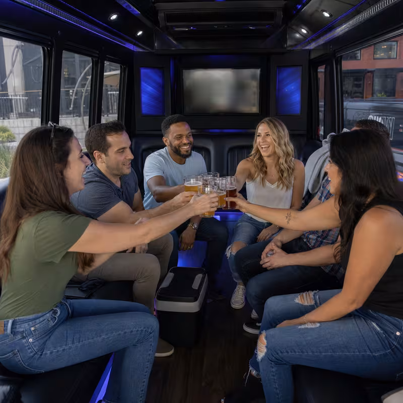 Group boarding a white charter bus for Winery & Brewery Tour Transportation transportation in San Bernadino