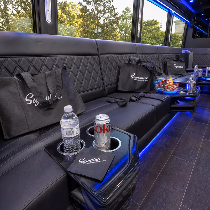 Party bus interior with wraparound leather seating and LED lighting in San Bernadino